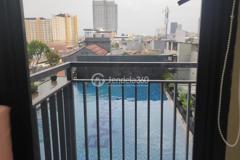 Balcony Homey Studio Apartment at Evenciio Apartment Low Floor